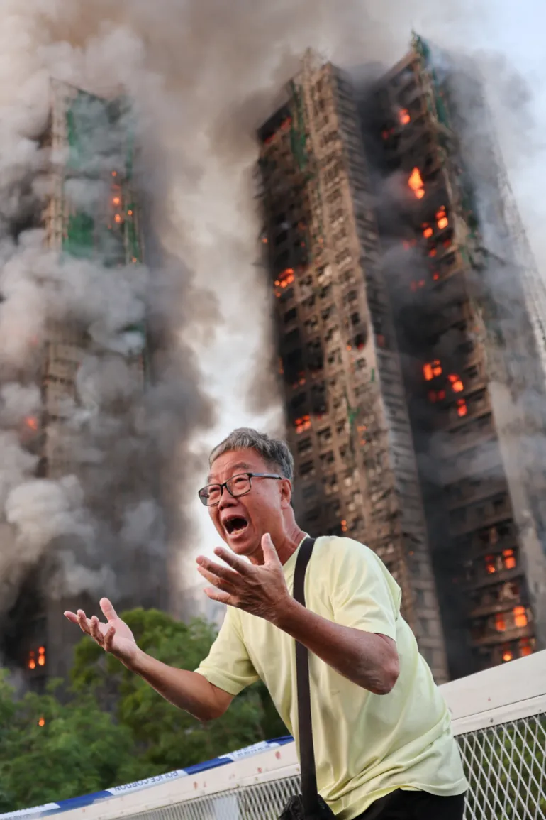 Wong 71, reacts after claiming his wife is trapped inside Wang Fuk Court during a major fire