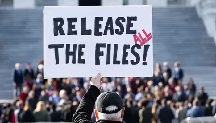 A protester holds a sign related to the release of the Jeffrey Epstein case files outside the US Capitol in Washington, DC, on November 12, 2025. — Reuters