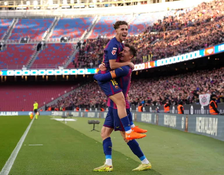 BARCELONA, SPAIN - NOVEMBER 22: Robert Lewandowski of FC Barcelona celebrates scoring his team's first goal with teammate Fermin Lopez during the LaLiga EA Sports match between FC Barcelona and Athletic Club at Spotify Camp Nou on November 22, 2025 in Barcelona, Spain. (Photo by Alex Caparros/Getty Images)