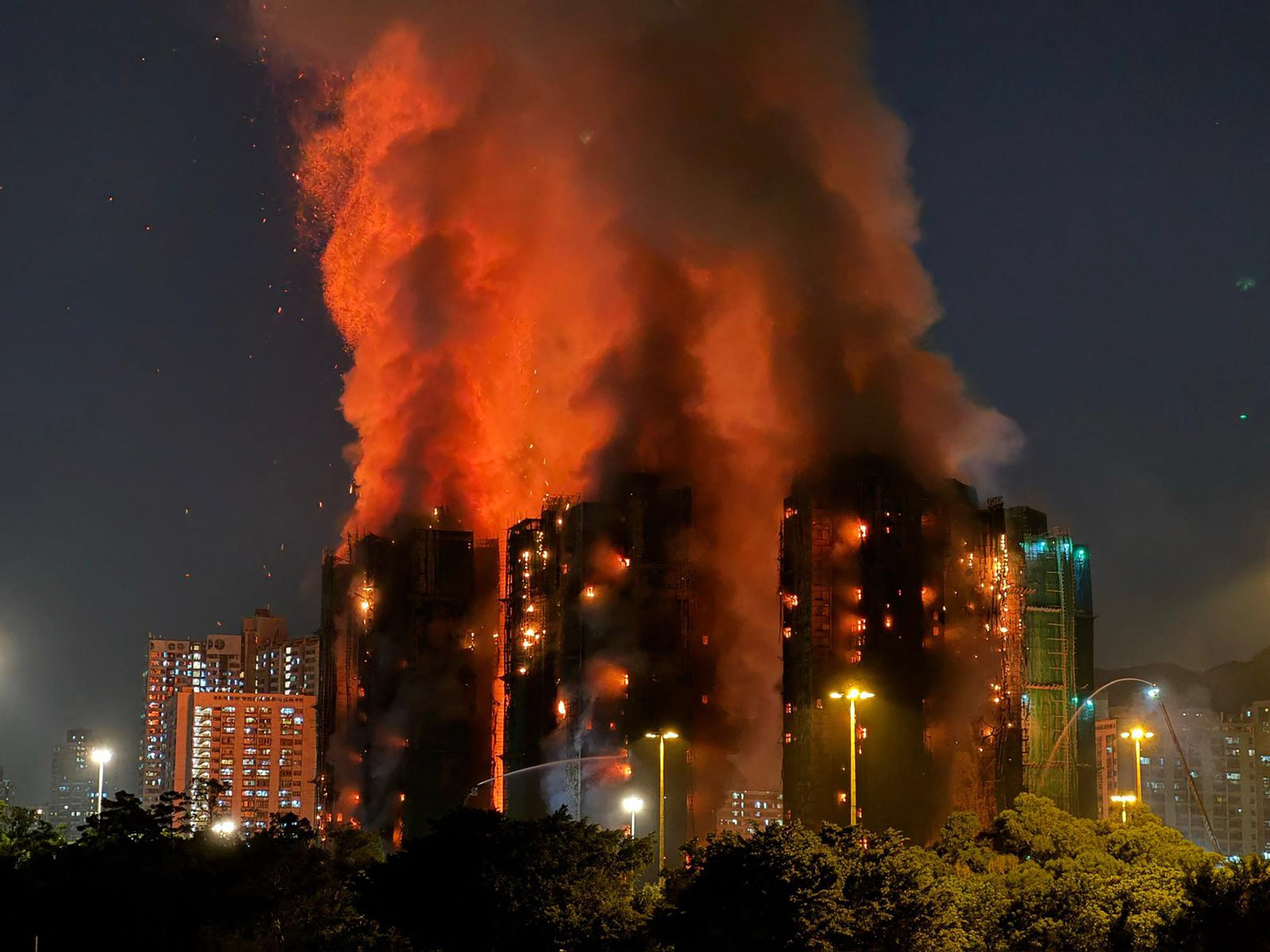 Thick smoke and flames rise as a major fire engulfs several apartment blocks at the Wang Fuk Court residential estate in Hong Kong's Tai Po district on November 26, 2025. At least four people were killed when a fire engulfed several high-rise blocks in a Hong Kong residential estate on November 26, the government said, with media reporting that some residents were trapped inside. Photo: AFP