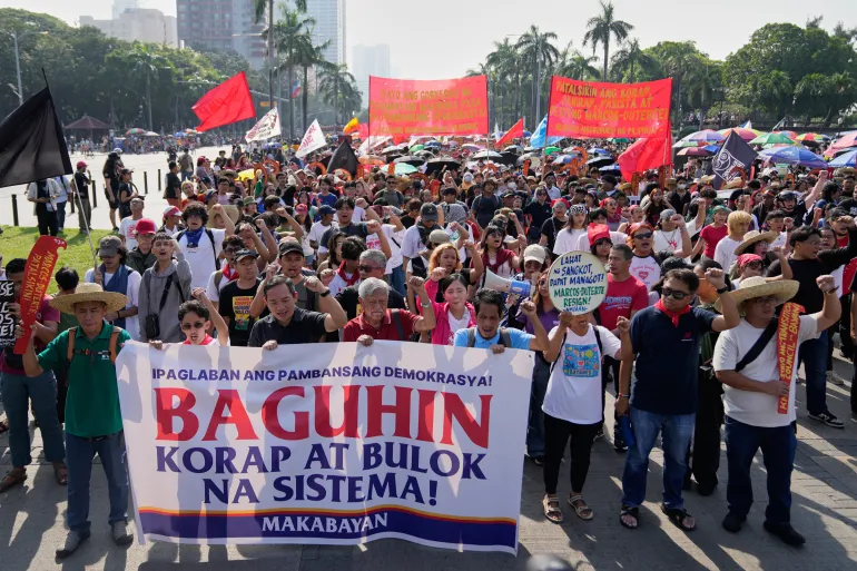Protesters shout slogans during anti-corruption protest in Manila, Philippines on Sunday Nov. 30, 2025. (AP Photo/Aaron Favila)