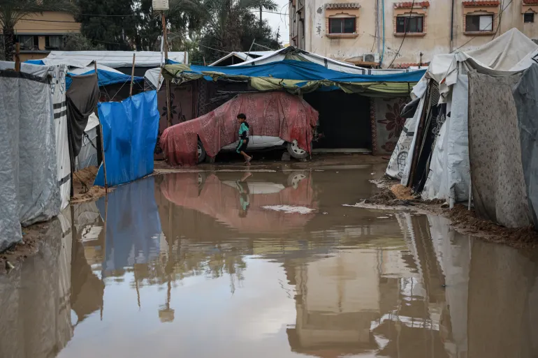 A waterlogged area between tents