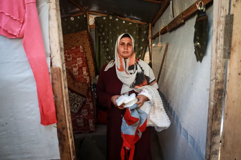 A woman holds her belongings