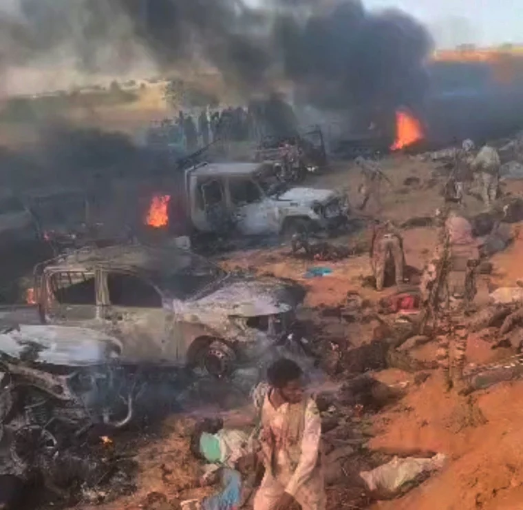 RSF forces walk amid the bodies of unarmed people and burning vehicles, during an attack, near al-Fasher, Sudan, in this image from video released on Oct. 27, 2025.