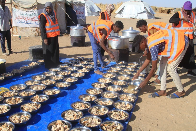 Sudanese volunteers prepare free meals for those who fled el-Fasher at the al-Afad camp on Nov. 20.