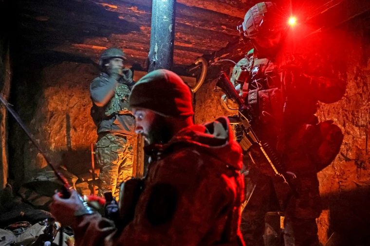 Ukrainian servicemen prepare a combat mission in a dugout at a position in the frontline town of Kostiantynivka