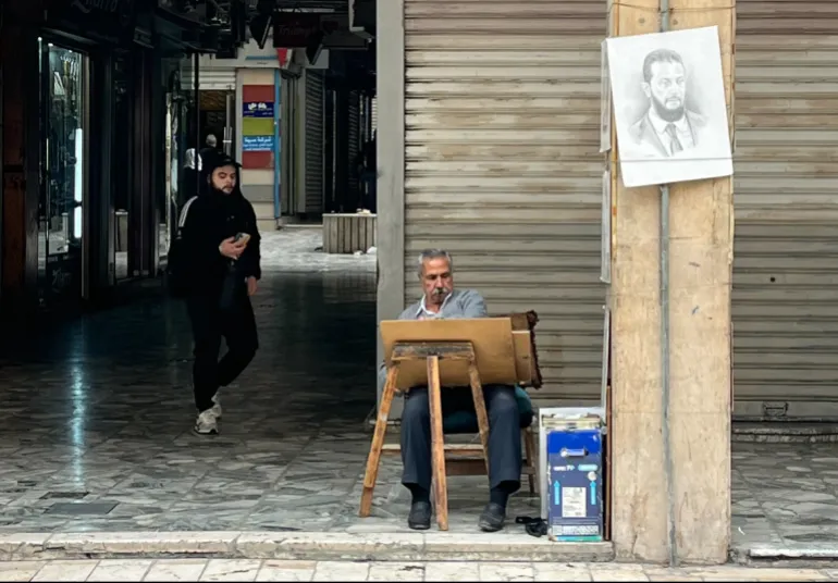 A street artist in the al-Salhiye souk in Damascus. [Justin Salhani/Al Jazeera]