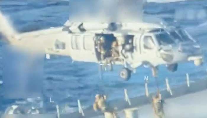 US forces abseil onto an oil tanker during a raid described by US Attorney General Pam Bondi as its seizure by the United States off the coast of Venezuela, on December 10, 2025. — Reuters