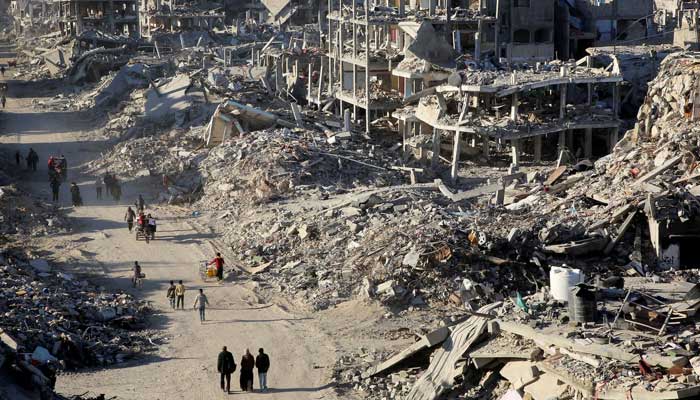 Palestinians walk past the rubble of houses and buildings destroyed during the war, following a ceasefire between Israel and Hamas, in Rafah in the southern Gaza Strip on January 20, 2025. — Reuters