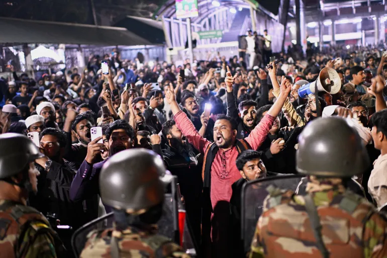 Protesters shout slogans in front of the premises of the Prothom Alo daily newspaper after news reached the country from Singapore of the death of a prominent activist Sharif Osman Hadi, in Dhaka, Bangladesh, Friday, Dec. 19, 2025. (AP Photo/Mahmud Hossain Opu)
