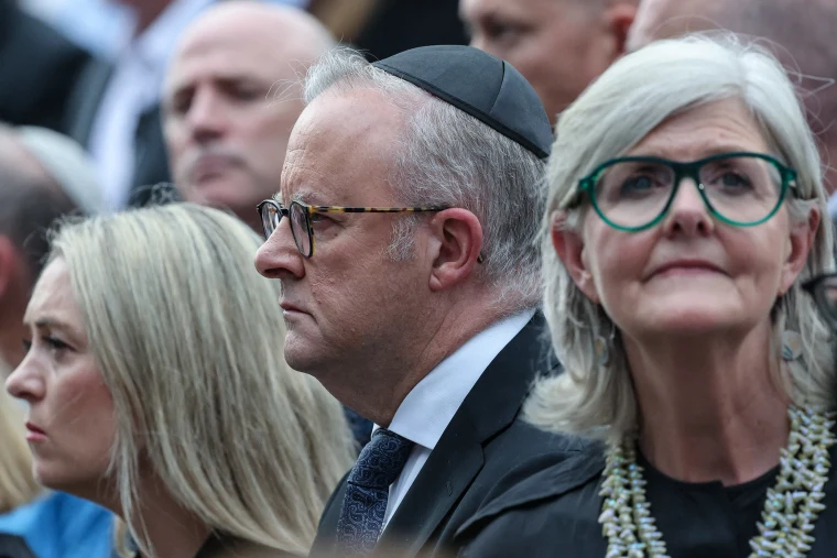 Australia's Prime Minister Anthony Albanese (C), his wife Jodie Haydon (L) and Australia's Governor General Sam Mostyn (R) attend the memorial held for the victims of a shooting at Bondi Beach on Sunday. 