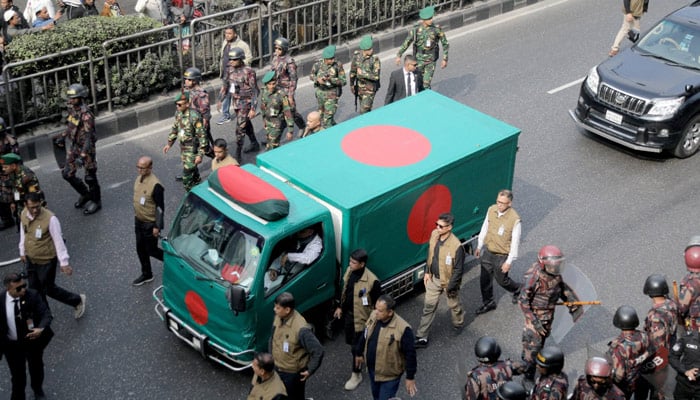 Security forces escort a flag-draped vehicle carrying the body of Bangladeshs former Prime Minister Khaleda Zia for her funeral in Dhaka, Bangladesh, December 31, 2025. — Reuters