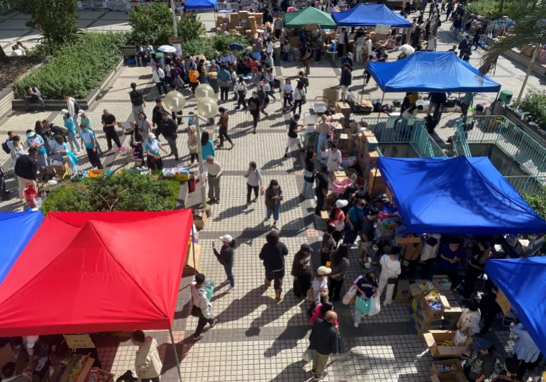 People visit a resource collection point set up by volunteers to provide supplies for residents impacted by the deadly fire, near the Wang Fuk Court housing complex in Tai Po, Hong Kong, China November 28, 2025. REUTERS/Jessie Pang