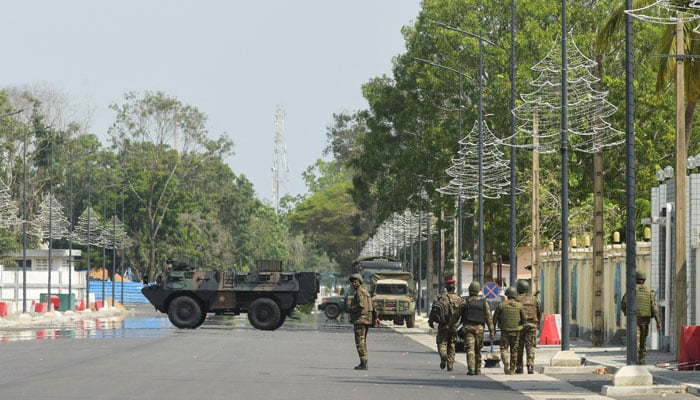 Soldiers patrol in front of the headquarters of Benins radio and television station, after, according to Benins Interior Minister, the countrys armed forces thwarted the attempted coup against the government of Benins President Patrice Talon, in Cotonou, Benin, December 7, 2025. — Reuters
