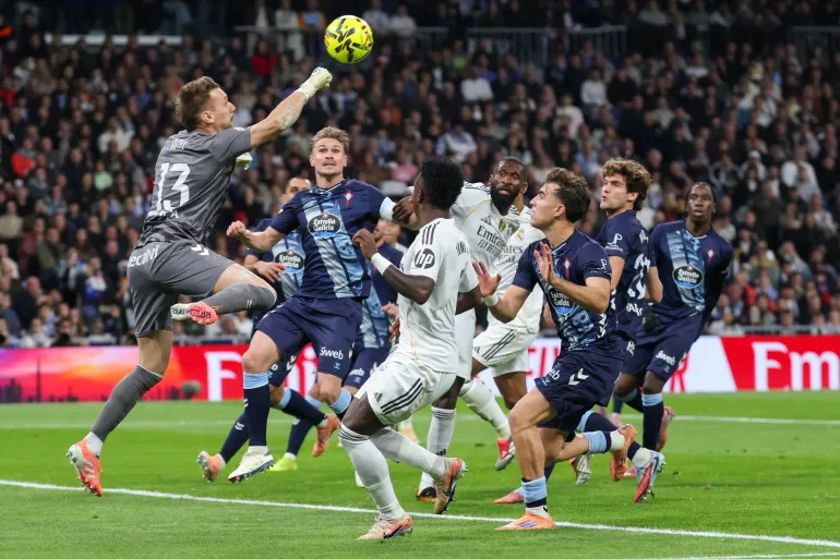 Celta Vigo's Romanian goalkeeper #13 Ionut Andrei Radu (L) hits the ball during the Spanish league football match between Real Madrid CF and RC Celta de Vigo at the Santiago Bernabeu Stadium in Madrid on December 7, 2025. (Photo by Thomas COEX / AFP)