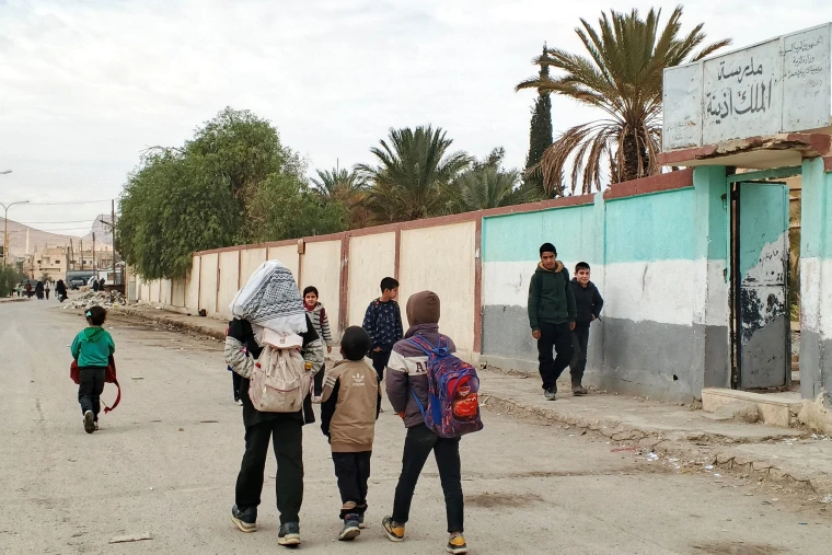 People walk along a street in Palmyra, central Syria, Dec. 14, 2025. TO GO WITH "Feature: Residents in Syria's Palmyra recall tense hours after attack kills U.S. service members" 