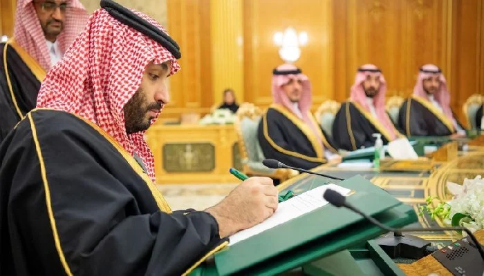 This handout picture provided by the Saudi Royal Palace shows Saudi Crown Prince Mohammed bin Salman signing the state budget during a ministerial council meeting in the capital Riyadh, on December 7, 2022. — AFP