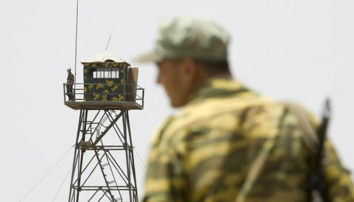 A frontier guard stands on a bridge to Afghanistan across Panj river in Panji Poyon border outpost, south of Dushanbe, Tajikistan. — Reuters/File