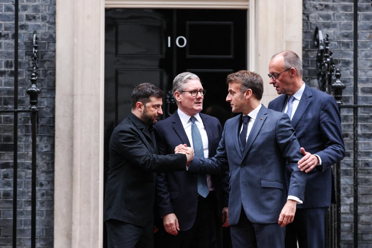Ukraine's President Volodymyr Zelenskyy, left, and France's President Emmanuel Macron shake hands on the 10 Downing Street doorstep after a meeting with Britain's Prime Minister Keir Starmer, center, and Germany's Chancellor Friedrich Merz, right