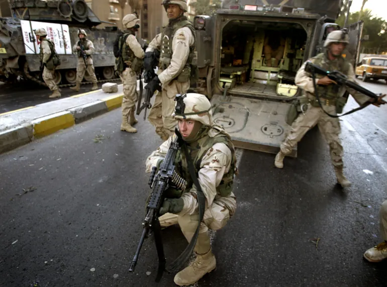 U.S. soldiers arrive at the site of morning attacks in central Baghdad November 21, 2003. 