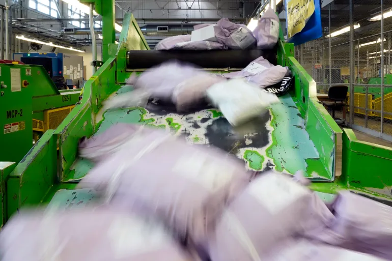 Parcels slide down a ramp after being scanned at the U.S. Customs and Border Protection overseas mail inspection facility at Chicago's O'Hare International Airport in USA