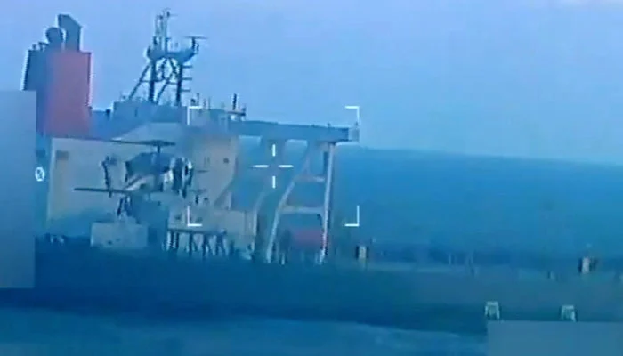 A US military helicopter flies near an oil tanker during a raid described by US Attorney General Pam Bondi as its seizure by the United States off the coast of Venezuela, December 10, 2025, in a still image from video. — Reuters