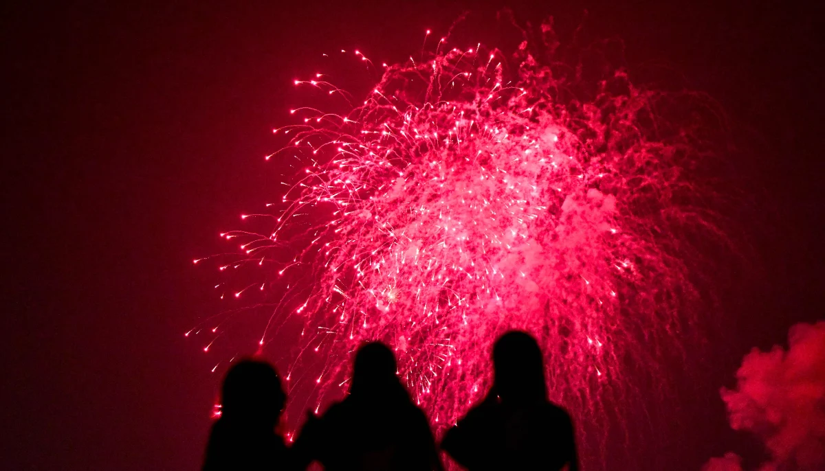 People watch fireworks explode over the port city as part of the New Year celebrations in Colombo on December 31, 2025. — AFP