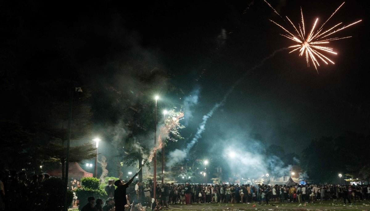 Revellers let off fireworks as they celebrate the New Year in Alun-Alun Kota Gianyar in Bali, on January 1, 2026. — AFP