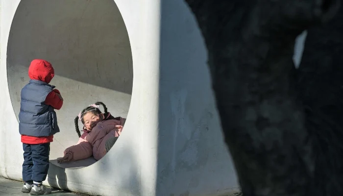 Children play at a park in Beijing on January 3, 2026. — AFP