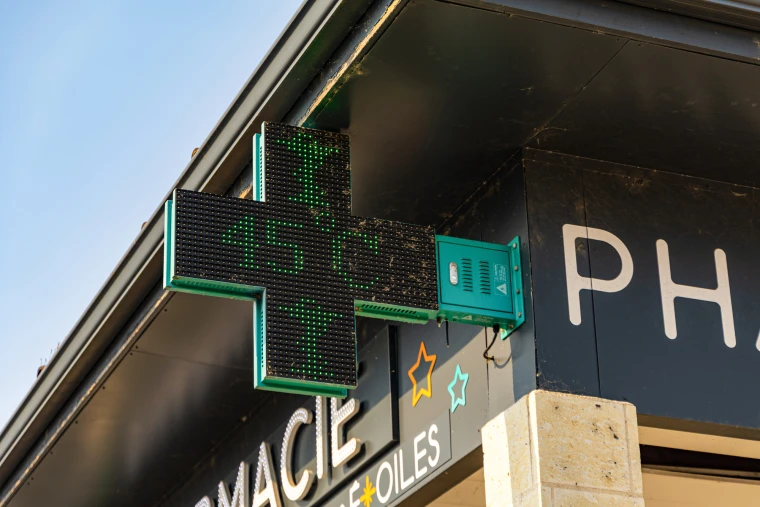 a thermometer above a pharmacy entrance shows 45 degrees Celsius