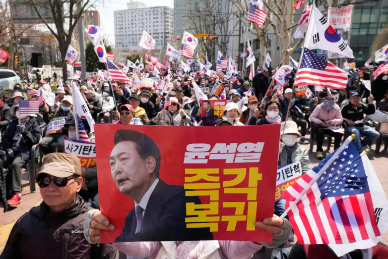 Supporters of impeached South Korean President Yoon Suk Yeol stage a rally to oppose his impeachment near the Constitutional Court in Seoul, South Korea, Thursday, April 3, 2025. The letters read "Yoon Suk Yeol's immediate return." (AP Photo/Ahn Young-joon)