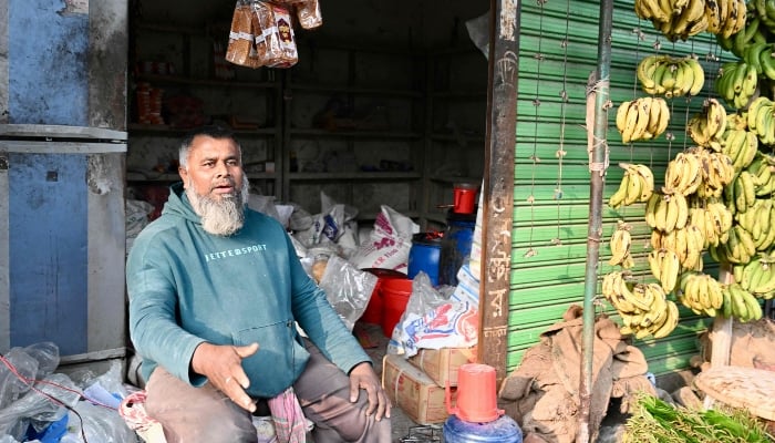 This photograph, taken on January 14, 2026, shows banana and betel leaf seller Mohammad Shafayet Biswas speaking during an interview with AFP in Gopalganj, Bangladesh. — AFP