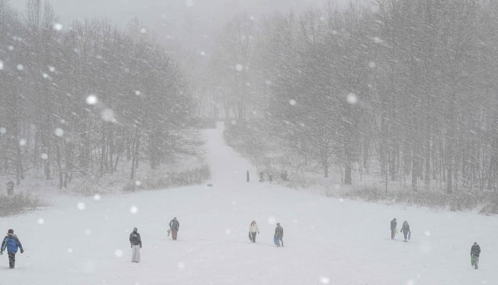 People sled on a snow-covered hill in Cherokee Park on January 25, 2026 in Louisville, Kentucky, US, January 25, 2026. — AFP
