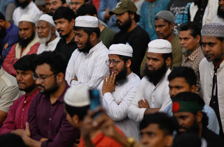 People react as they gather to perform funeral prayers for leading Bangladeshi activist Sharif Osman Hadi, who died from gunshot wounds sustained in an attack in Dhaka earlier this month, outside the nation's Parliament complex in Dhaka, Bangladesh, Saturday, Dec. 20, 2025. (AP Photo/Mahmud Hossain Opu)