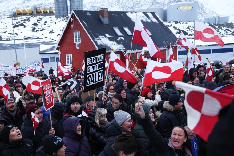 People bear Greenlandic flags as they gather in front of the U.S. consulate protest against U.S. President Donald Trump and his announced intent to acquire Greenland on January 17, 2026 in Nuuk, Greenland.