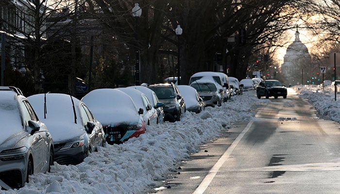 Cars wait for their owners to dig them out as roads near the US Capitol begin to clear, in the aftermath of a major winter storm that dumped snow and ice across a large swath of the United States, in Washington, DC on January 26, 2026. — Reuters