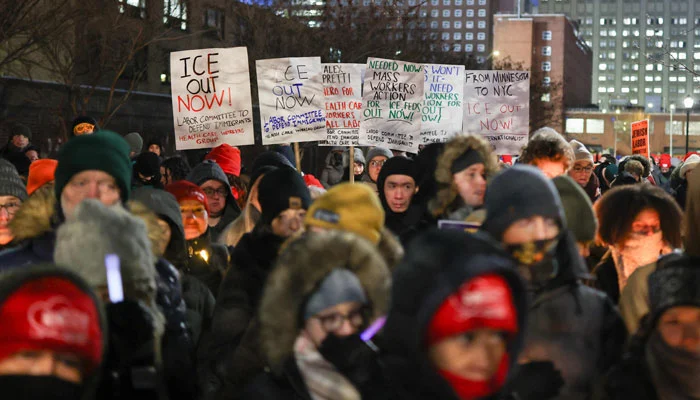 People hold signs and candles during a vigil for Alex Pretti, a 37-year-old nurse who was fatally shot by immigration agents in Minneapolis, at the Veterans Affairs NY Harbor Healthcare System Manhattan Campus in New York, on January 29, 2026. — AFP