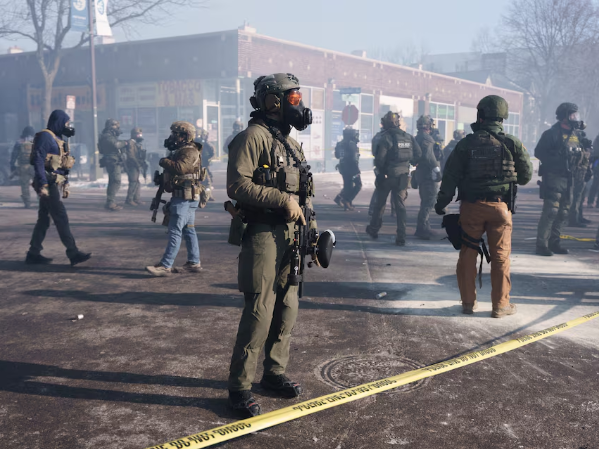 Federal agents stand amid teargas near the site where a man identified as Alex Pretti was fatally shot by federal agents trying to detain him, in Minneapolis, Minnesota, US, January 24, 2026 PHOTO: REUTERS