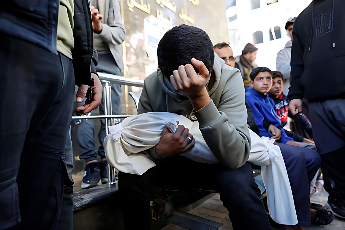 A Palestinian man carries the body of his 5-month-old brother, Ahmed Al-Nader, who was reportedly killed the previous day along with other family members in an Israeli shelling on a school-turned-shelter in the Tuffah neighbourhood of Gaza City, ahead of his funeral. PHOTO: AFP