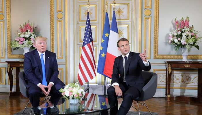 US President Donald Trump and French President Emmanuel Macron speak during a meeting at the Prefecture of Caen, Normandy, France. — Reuters