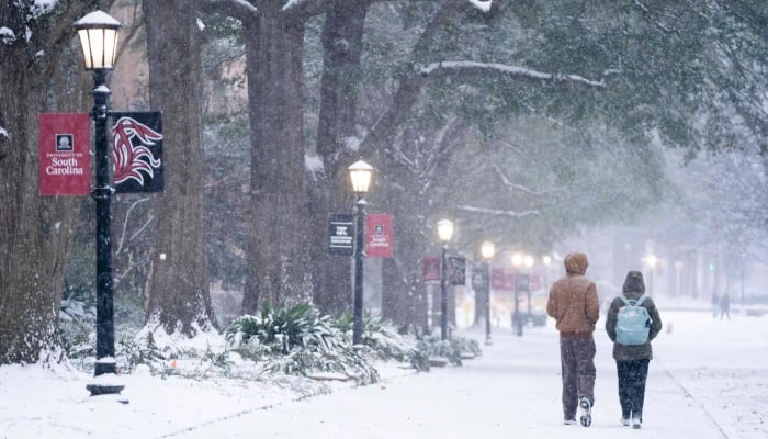 Students walk across the historic Horseshoe as snow falls at the University of South Carolina on January 31, 2026, in Columbia, South Carolina, US. — AFP