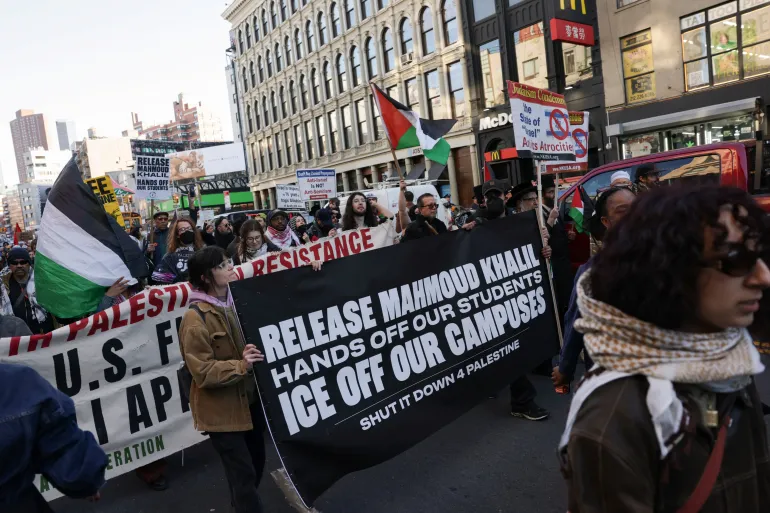 Demonstrators hold banners as they march during a protest following the arrest by US immigration agents of Palestinian student protester Mahmoud Khalil at Columbia University, in New York City, U.S., March 10, 2025. REUTERS/Jeenah Moon