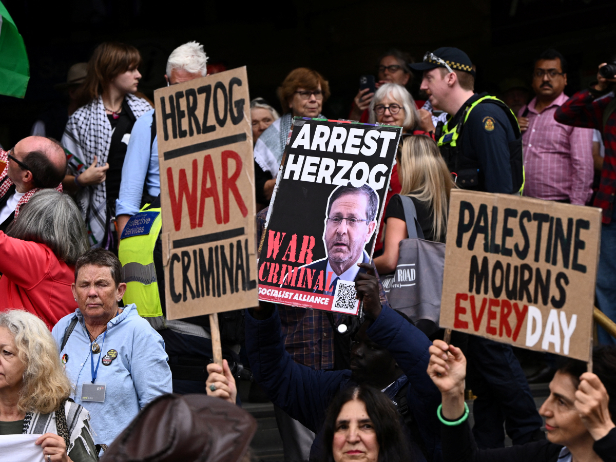 Demonstrators gather during a protest against Israeli President Isaac Herzog's visit to Australia, at Flinders Street Station in Melbourne, Australia, February 9, 2026. SOURCE: REUTERS