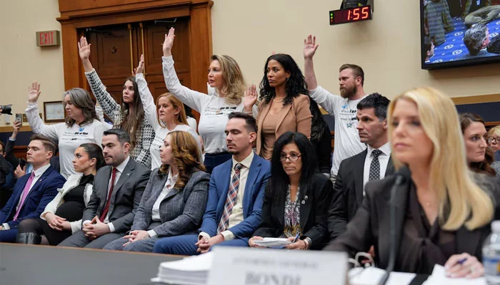 Survivors of Jeffrey Epstein raise their hands after US Representative Pramila Jayapal (D-WA) asked who of them has been unable to meet with the US Department of Justice led by Attorney General Pam Bondi, as Bondi attends a House Judiciary Committee hearing on oversight of the Justice Department to testify, on Capitol Hill in Washington. — Reuters