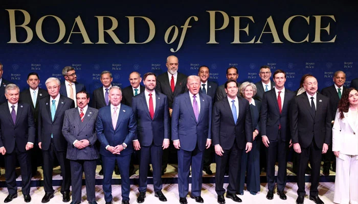 US President Donald Trump stands with world leaders participating in the inaugural Board of Peace meeting at the US Institute of Peace in Washington DC, February 19, 2026. — Reuters