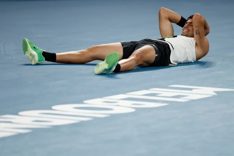 MELBOURNE, AUSTRALIA - FEBRUARY 01: Carlos Alcaraz of Spain celebrates his victory in the Men's Singles Final against Novak Djokovic of Serbia during day 15 of the 2026 Australian Open at Melbourne Park on February 01, 2026 in Melbourne, Australia. (Photo by Darrian Traynor/Getty Images)