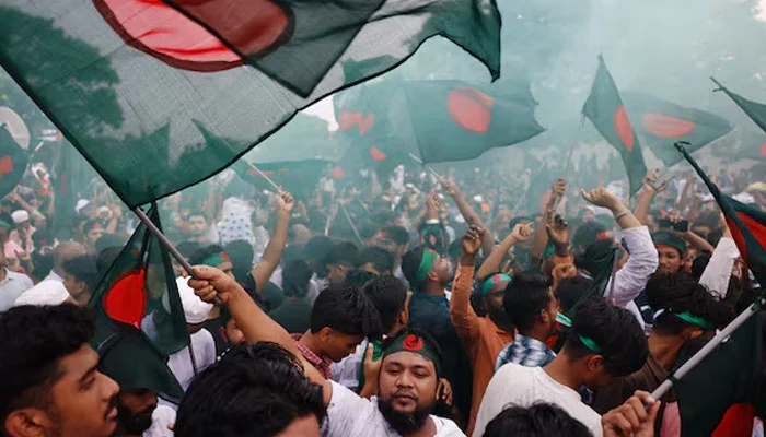 People wave flags during celebrations marking the one-year anniversary of student-led protests that led to the ousting of Bangladeshi then-Prime-Minister Sheikh Hasina, at Manik Mia Avenue, outside the parliament building, in Dhaka, Bangladesh, August 5, 2025. — Reuters