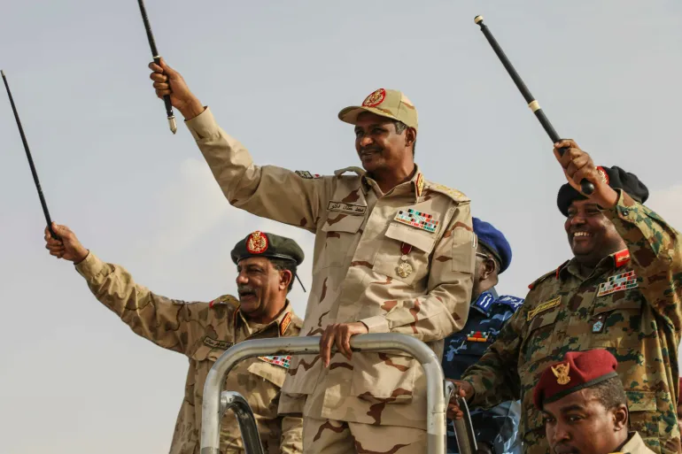 FILE - Gen. Mohammed Hamdan Dagalo, center, greets the crowd during a military-backed tribes' rally in the Nile River State of Sudan, on Saturday, July 13, 2019. (AP Photo/Mahmoud Hjaj,File)