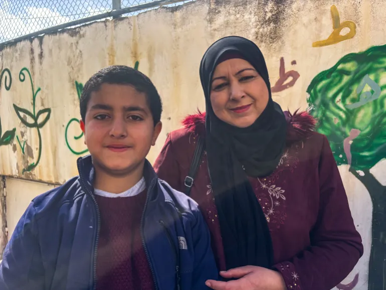 Eman Hassaneh and her 10-year-old son, Zaid [Al Jazeera]