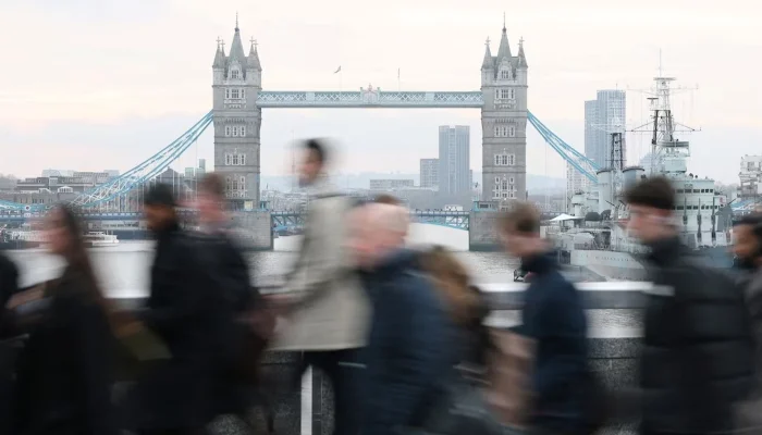 Workers cross London Bridge during the morning rush hour with Tower Bridge seen behind, in London, Britain, December 16, 2025. — Reuters